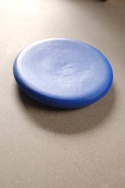 Bubble Plate set on a neutral table at a three-quarter angle, showing its low profile, rounded rim, and soft cast shadow.