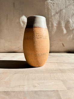 High Desert Vase in short barrel shape without botanicals, showing textured raw clay body and horizontally grooved glazed rim