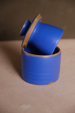 Butterbell ceramic keeper with vibrant cobalt blue satin glaze, bell lid leaning inside crock with exposed raw clay rims.