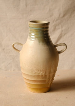 Woodfire Amphora # 4 front view with two loop handles, grooved neck, and textured body on neutral fabric.