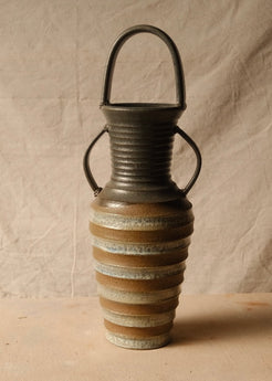 Eros Amphora angled front view showing the textured horizontal ridges and glazed bands across the tapered body.