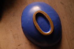 Wander Footed Oval Server turned upside down to show the smooth blue underside and unglazed raw clay foot ring.