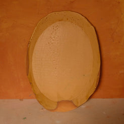 Wide Tera Platter with glossy ochre glaze and fine specks, standing upright displaying an oval basin and flared rim.
