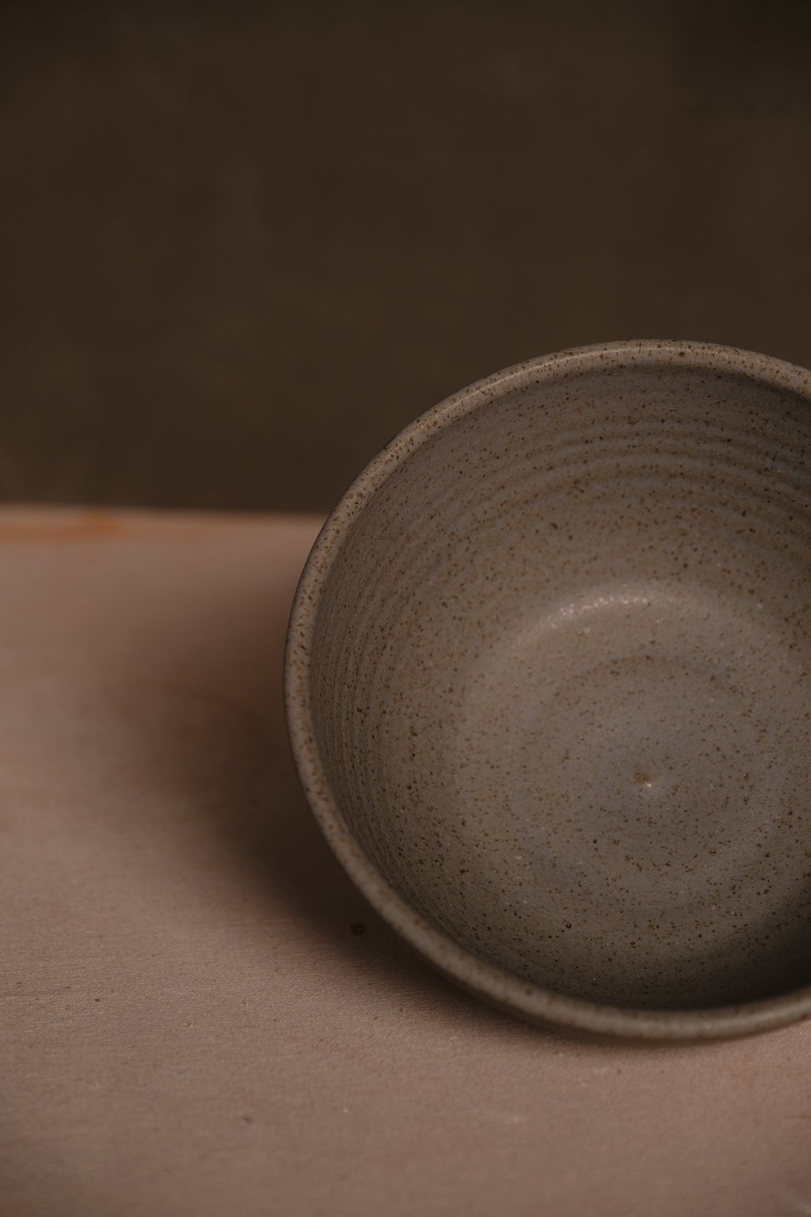 Speckled Buff Ramen Bowl, overhead interior view of an empty stoneware bowl showing rounded base