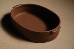 Iron Hot Dish ceramic casserole dish shown in a horizontal three-quarter view, highlighting side tab handles.