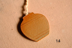 Ceramic ornament round jar shape with three horizontal rows of stamped dashed indentations, numbered fourteen on fabric.