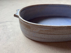 Speckle Cenote Hot Dish, eye-level side profile showing horizontal carved grooves, tab handle, and speckled exterior.