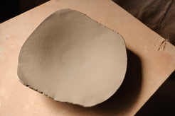 Mesa Platter with smooth pale surface, seen from an elevated angle showing wide shallow bowl structure.