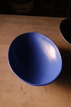 Wander Footed Oval Server in bright blue glaze, seen from above looking down into the shallow ceramic basin.