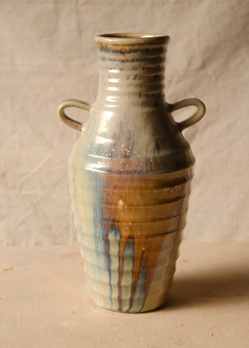Woodfire Amphora #3 upright on a flat surface, showing prominent two-handled profile and bold woodfire ash drips.