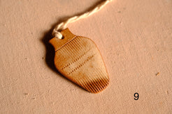 Ceramic ornament vase silhouette with comb-textured line patterns on the top and bottom sections, numbered nine.