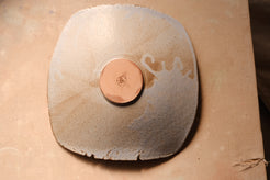 Mesa Platter underside view from directly above, highlighting the raw clay round foot and glaze drip edge.