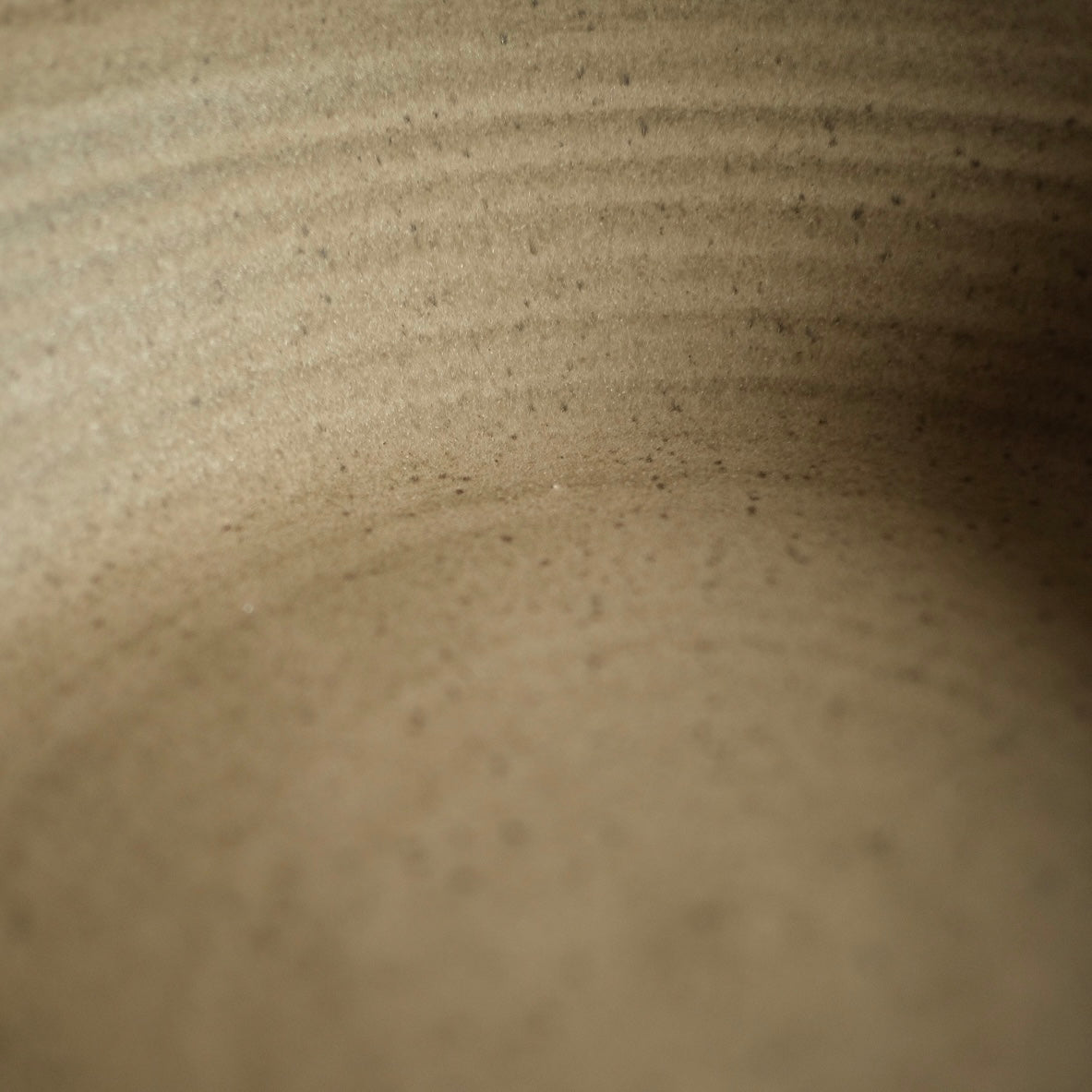 Fat Rim Dinner Plate glaze swatch, close-up of unglazed textured stoneware showing fine wheel ridges.