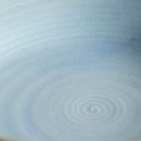 Fat Rim Dinner Plate glaze swatch, close-up of pale blue-grey glaze showing subtle spiral center ridges.