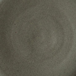 Fat Rim Dinner Plate glaze swatch, macro view of deep taupe-grey speckled matte stoneware.