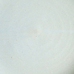 Fat Rim Dinner Plate glaze swatch, close-up of warm off-white glaze with subtle earthy speckles.