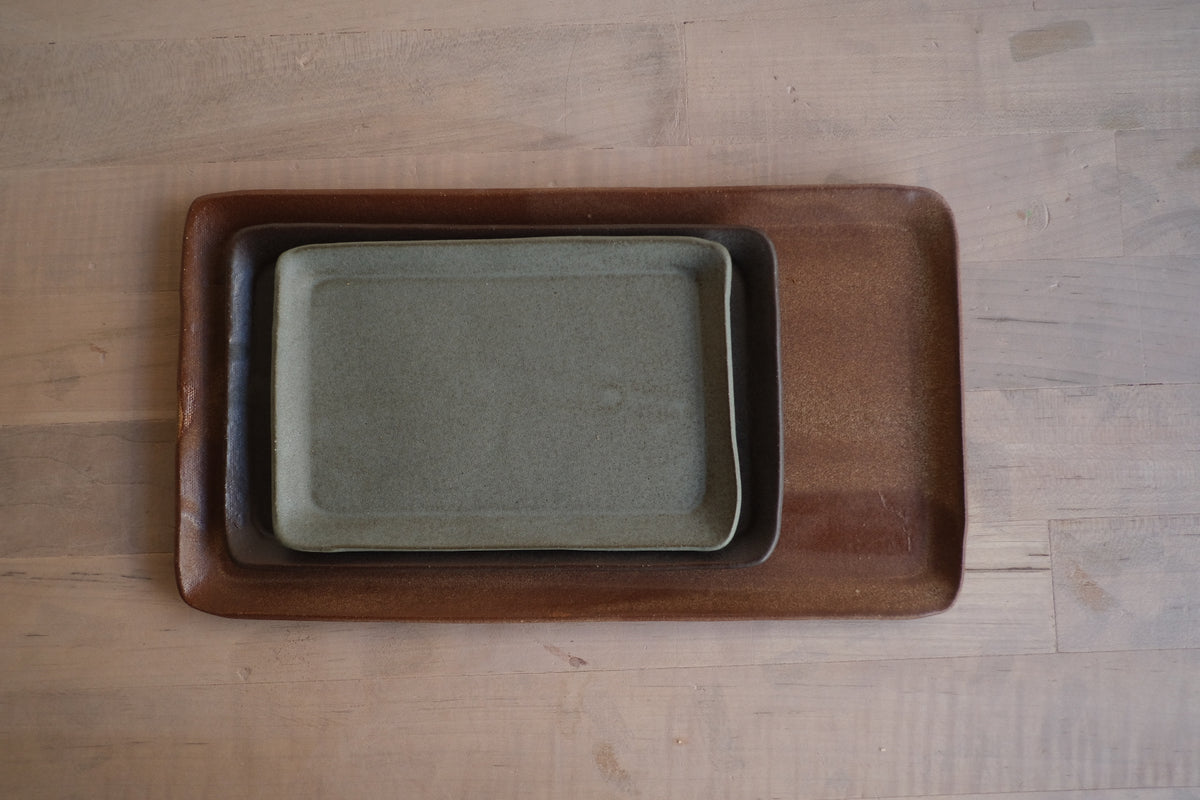Trinket Tray trio stacked neatly inside each other from largest to smallest on a light wood tabletop, top-down view.