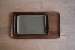 Trinket Tray trio stacked neatly inside each other from largest to smallest on a light wood tabletop, top-down view.