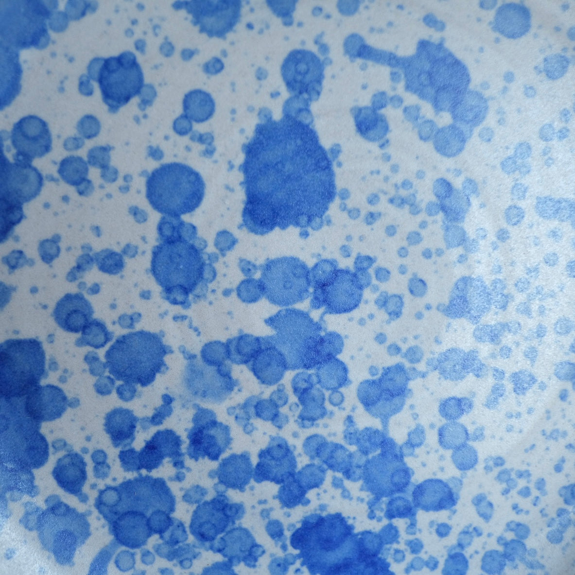 Fat Rim Dinner Plate glaze swatch, macro detail of dense blue ink-splatter pattern on white stoneware.