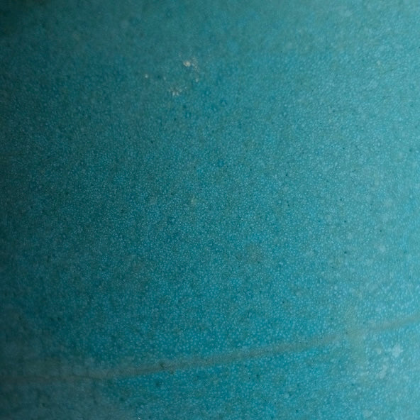 Fat Rim Dinner Plate glaze swatch, close-up of mottled aqua-blue satin ceramic glaze texture.
