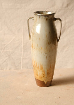 Woodfire Amphora #5 reverse view, showing running glaze drips above the unglazed foot and two loop handles on cloth.