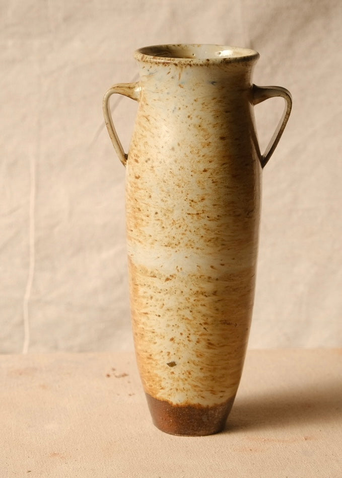 Woodfire Amphora #6, tall ceramic vase with two loop handles, speckled glaze, and unglazed dark foot.