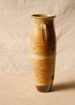Woodfire Amphora #6, side profile highlighting a single strap handle, warm flashed glaze, and dark raw clay base.