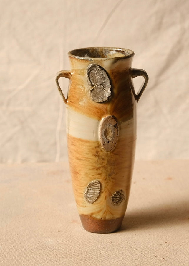 Woodfire Amphora #7, front view showing four textured shell and oval wadding marks embedded across the glazed ceramic body