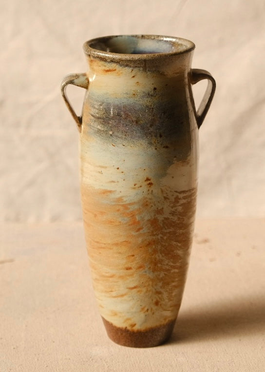 Woodfire Amphora #7, tall ceramic vase with two loop handles, smooth ash glaze surface, and unglazed foot on cloth