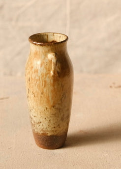 Woodfire Amphora #8 rotated in side profile on canvas, showing one looped handle centered and an unglazed lower foot.