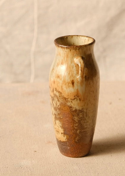 Woodfire Amphora #8 turned to reveal heavy toasted ash flashes across its slender ceramic body and exposed clay foot.