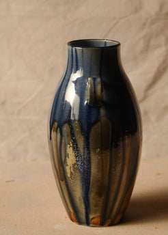 Woodfire Amphora #9, side profile showing one handle centered and vertical speckled glaze runs over warm clay.