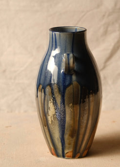 Woodfire Amphora #9, angled profile view rotated slightly, showing pale mottling in the dark downward glaze drips.