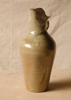 Woodfire Carafe viewed head-on from the flared torn spout, with the handle visible protruding to the right behind it.