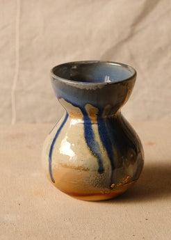Woodfire Sake Carafe #1 viewed from another side, displaying broad vertical glaze runs over an unglazed foot.