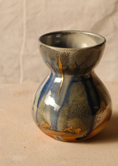 Woodfire Sake Carafe #1 rotated to reveal a mottled darker glaze face with a thin golden drip mark at the neck.