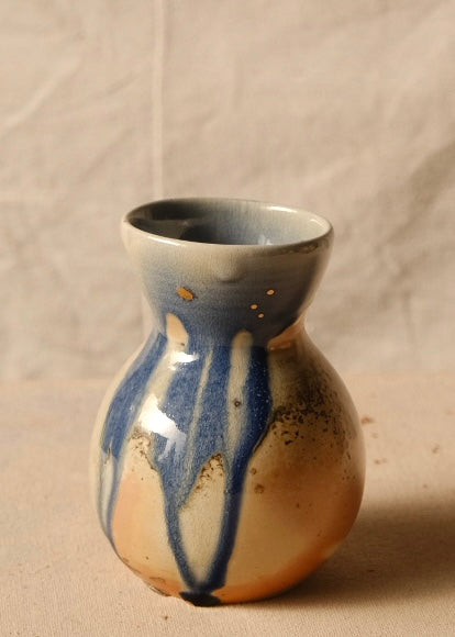 Woodfire Sake Carafe #2 standing upright, highlighting long blue glaze drips running down the front of the bulbous body.