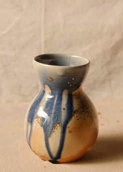 Woodfire Sake Carafe #2 standing upright, highlighting long blue glaze drips running down the front of the bulbous body.