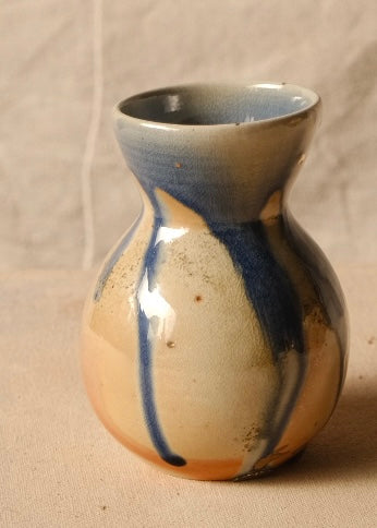 Woodfire Sake Carafe #2 angled slightly right, showing glossy dripping blue glaze streaks over warm wood-fired flashing.