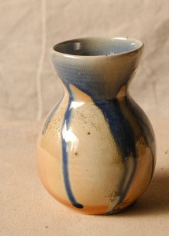 Woodfire Sake Carafe #2 angled slightly right, showing glossy dripping blue glaze streaks over warm wood-fired flashing.