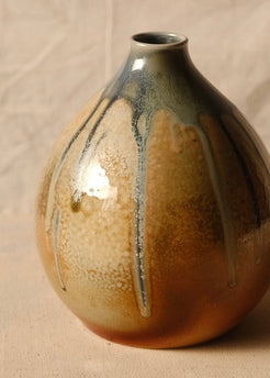 Woodfire Orbe Vase angled to show lighter ash-deposit patterning and long vertical glaze drips.