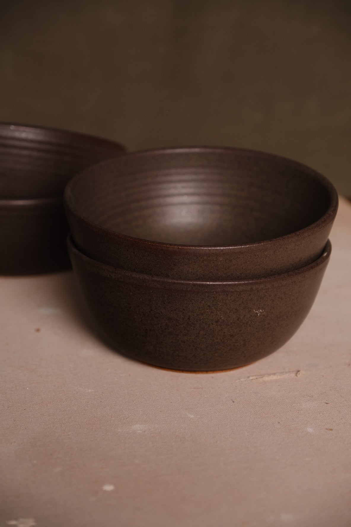 Speckled Buff Ramen Bowl, two nested bowls on fabric, showing exterior body with another stack blurred behind