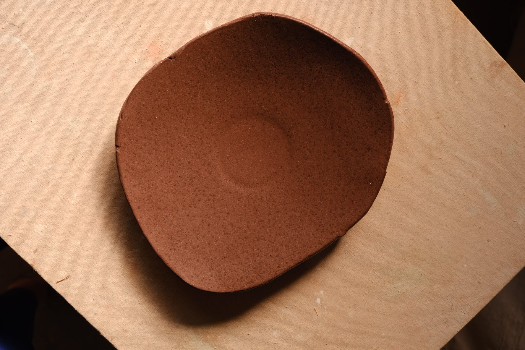 Mesa Platter with speckled glaze and hand-shaped rim viewed directly from above on a flat work surface.
