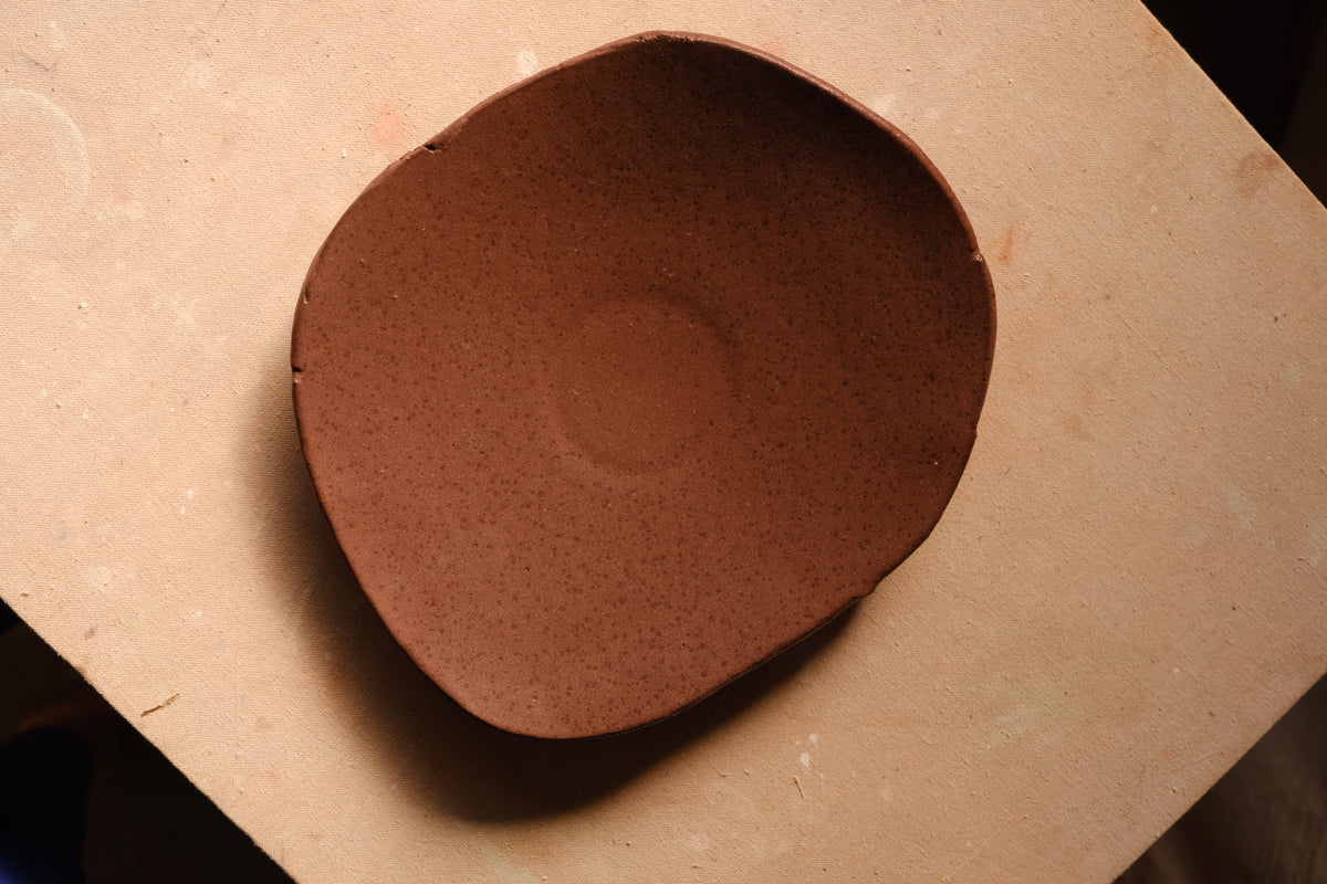 Mesa Platter with speckled glaze and hand-shaped rim viewed directly from above on a flat work surface.