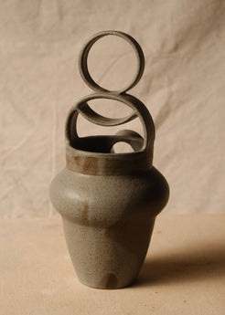 Rising Moon stoneware pitcher viewed from behind, highlighting the smooth back wall and stacked circular bridge handle.