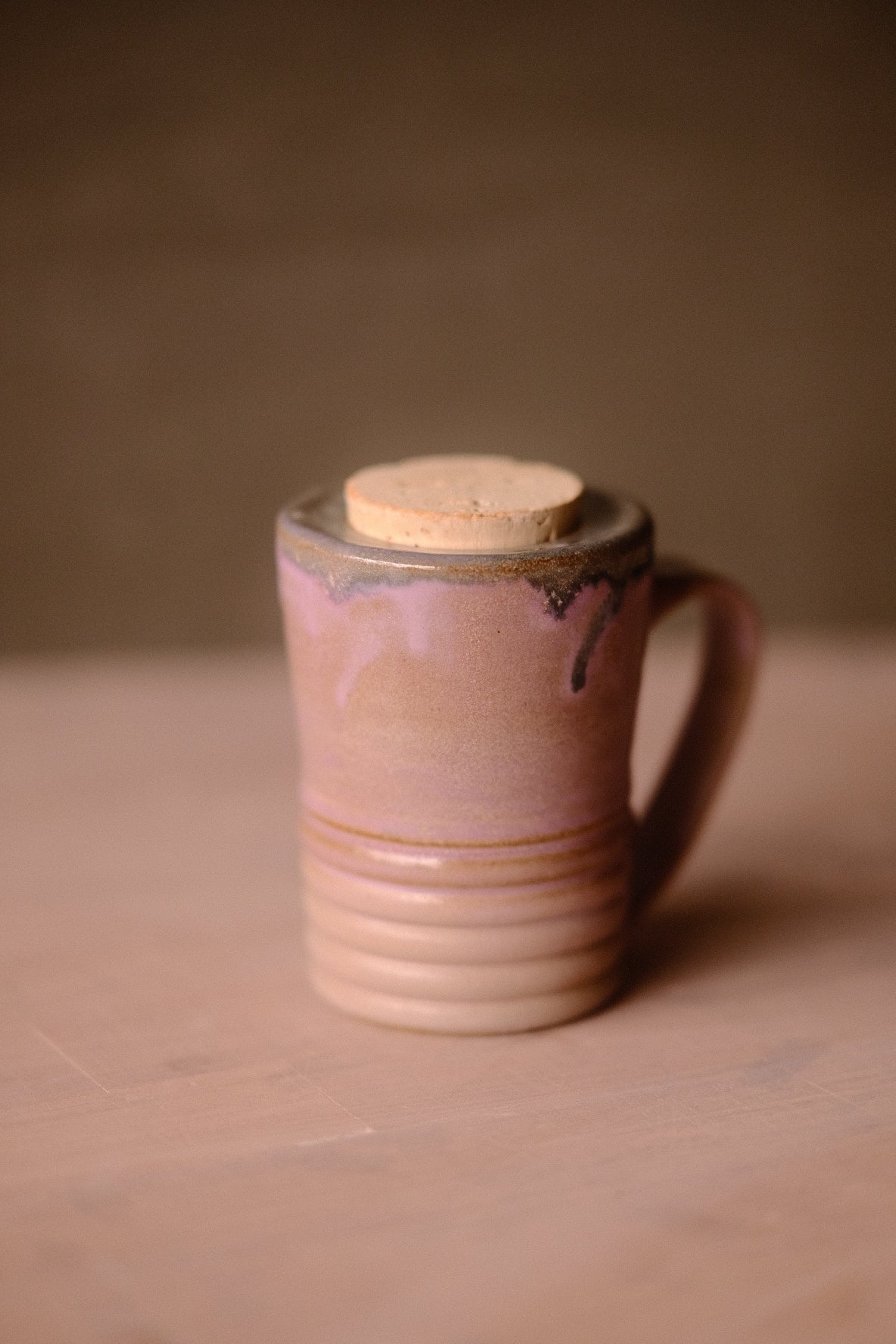 Lavendar Storm Traveller glazed mug with flush cork top and horizontal ridges, turned with handle on the right.