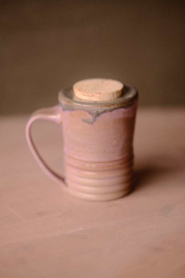 Lavendar Storm Traveller ceramic travel mug with cork stopper and ribbed base, handle on the left.