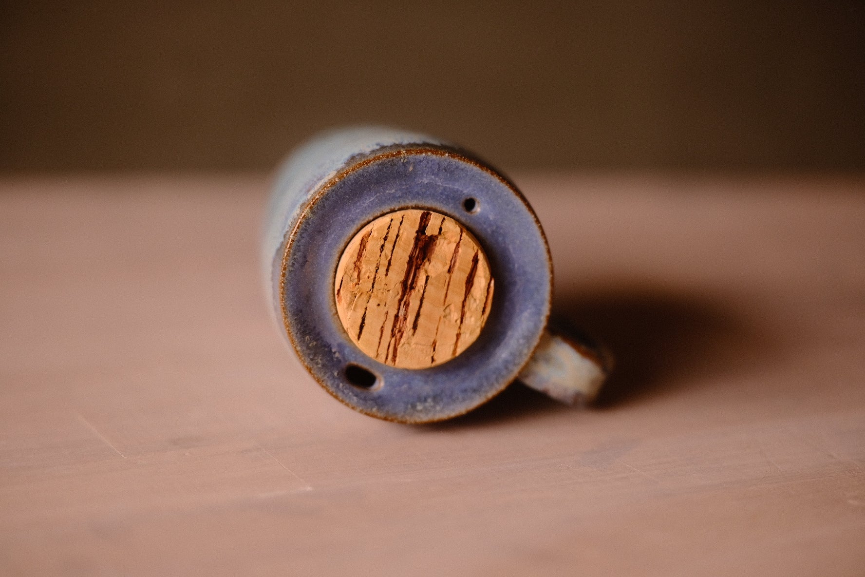 Secret Cenote Tall Traveller top view showing the recessed glazed lid, round cork stopper, sip hole, and air vent.