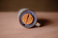 Secret Cenote Tall Traveller top view showing the recessed glazed lid, round cork stopper, sip hole, and air vent.