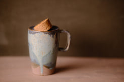 Secret Cenote Tall Traveller ceramic travel mug standing with its tapered cork stopper resting angled in the lid opening.